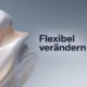 Abstrakte 3D-Skulptur auf hellem Hintergrund mit dem schwarzen Schriftzug „Flexibel verändern". Agiles Change Management